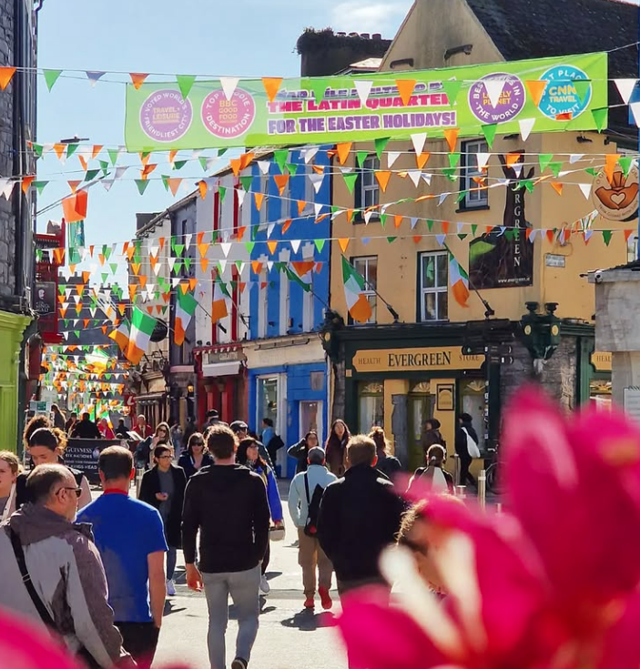 Lively street scene in Galway's Latin Quarter, featuring colourful shops and festive bunting, perfect for exploring local culture.