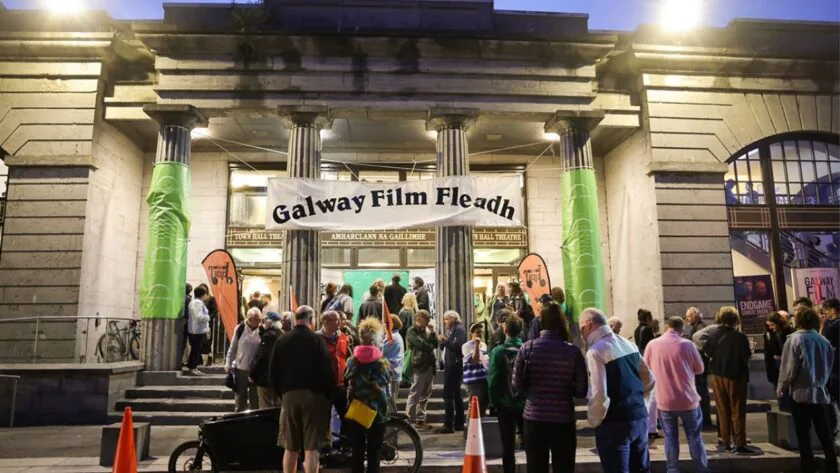 Guests gather at Galway Film Fleadh, enjoying vibrant cultural events at historic Town Hall Theatre's grand entrance.
